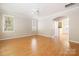 Bright, airy living room with hardwood floors, a ceiling fan, and large windows at 181 Singleton Rd, Mooresville, NC 28117