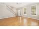 Inviting living room features hardwood floors, a staircase, and two bright windows at 181 Singleton Rd, Mooresville, NC 28117