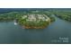 Picturesque aerial view of waterfront community with lush trees and a boat dock at 188 Lilac Mist Loop, Mooresville, NC 28115