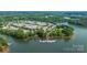 Aerial view of a lake community with a marina and boat slips and lush trees at 188 Lilac Mist Loop, Mooresville, NC 28115