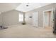 This is a bright bedroom with beige carpet and ample natural light from a window with white shutters at 188 Lilac Mist Loop, Mooresville, NC 28115