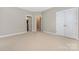 This is a large, carpeted bedroom with neutral walls and white trim, with entrances to other rooms at 188 Lilac Mist Loop, Mooresville, NC 28115