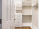 A well organized walk-in closet offers white shelving and drawers and wooden floors at 188 Lilac Mist Loop, Mooresville, NC 28115