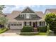 Charming craftsman-style home with a well-manicured lawn and a welcoming front porch at 188 Lilac Mist Loop, Mooresville, NC 28115