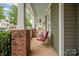 Charming front porch with seating, brick pillars, and ample space for relaxation at 188 Lilac Mist Loop, Mooresville, NC 28115