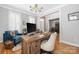 Cozy home office with a wooden desk, plush chair, and ample natural light at 188 Lilac Mist Loop, Mooresville, NC 28115