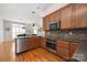 Well-lit kitchen featuring wooden cabinets, stainless steel appliances, and sleek countertops at 188 Lilac Mist Loop, Mooresville, NC 28115