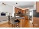 A cozy kitchen featuring wooden cabinets, granite countertops, and barstool seating at 188 Lilac Mist Loop, Mooresville, NC 28115