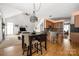 Open concept living space offers a dining table and chairs and bar seating at the kitchen counter at 188 Lilac Mist Loop, Mooresville, NC 28115