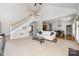 Open concept living room features neutral colors, comfortable seating and a staircase to the second floor at 188 Lilac Mist Loop, Mooresville, NC 28115