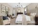 Comfortable main bedroom with a tufted headboard, soft linens, and ample seating at 188 Lilac Mist Loop, Mooresville, NC 28115
