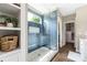 The glass enclosed shower offers blue tile, mosaic flooring and a large window at 188 Lilac Mist Loop, Mooresville, NC 28115