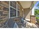 Inviting front porch with stone accents and cozy seating at 19455 Smith Cir, Cornelius, NC 28031