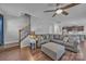 Cozy living room with wood floors, comfortable sectional, and staircase in the background at 19455 Smith Cir, Cornelius, NC 28031