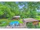 Overhead view of pool in backyard, shed, surrounded by lush trees and greenery at 200 W 14Th St, Salisbury, NC 28144