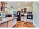 Well-lit kitchen featuring custom cabinets, hardwood floors and stainless-steel appliances at 200 W 14Th St, Salisbury, NC 28144