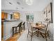 Bright dining area with wood floors, kitchen view, and stylish pendant lighting at 201 N Dotger Ave # C8, Charlotte, NC 28207