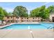 Outdoor swimming pool with lounge chairs surrounded by lush landscaping at 201 N Dotger Ave # C8, Charlotte, NC 28207