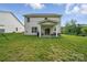 Backyard featuring patio, grill, green lawn, and wooded backdrop at 2034 Houle Ln, Charlotte, NC 28214