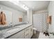 Modern bathroom with double sinks, granite countertops, and a shower with patterned curtains at 2034 Houle Ln, Charlotte, NC 28214