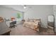 Bright bedroom with a daybed, hanging chair, desk, and plenty of natural light from the window at 2034 Houle Ln, Charlotte, NC 28214