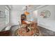 Formal dining room with a round wood table and bright natural light from large windows at 2034 Houle Ln, Charlotte, NC 28214