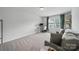 Bright home office space with neutral tones, a large window, and comfortable seating at 2034 Houle Ln, Charlotte, NC 28214