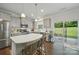 Modern kitchen features a center island, stainless steel appliances, and sliding glass doors to the yard at 2034 Houle Ln, Charlotte, NC 28214