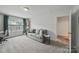 Comfortable living room featuring a gray sofa, bright windows, and a side table at 2034 Houle Ln, Charlotte, NC 28214
