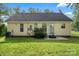 The backyard has a well-manicured lawn, concrete patio, trees, and an air conditioning unit at 209 Mcfadden St, Rock Hill, SC 29730