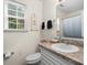 This bathroom offers a single sink vanity, toilet, mirror, and window offering natural light at 209 Mcfadden St, Rock Hill, SC 29730