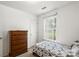 This bedroom features a full-size bed, dresser, and window offering plenty of natural light at 209 Mcfadden St, Rock Hill, SC 29730