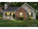 Charming one story home featuring a brick facade, covered front porch and well maintained lawn at 209 Mcfadden St, Rock Hill, SC 29730