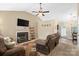 Cozy living room with a fireplace, ceiling fan, hardwood floors, and comfortable seating at 209 Mcfadden St, Rock Hill, SC 29730
