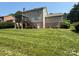 The backyard features a screened-in porch with wooden stairs and manicured lawn at 228 31St Avenue Ne Ct, Hickory, NC 28601