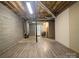 Unfinished basement with exposed ceiling, concrete block walls, and wood-look flooring at 228 31St Avenue Ne Ct, Hickory, NC 28601