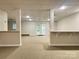 Unfinished basement featuring bright lighting, neutral carpeting, and glass doors to the outside at 228 31St Avenue Ne Ct, Hickory, NC 28601