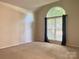 Bright bedroom with large arch window and neutral carpet and walls at 228 31St Avenue Ne Ct, Hickory, NC 28601