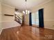 Bright dining room featuring hardwood floors, elegant chandelier, and large window with natural light at 228 31St Avenue Ne Ct, Hickory, NC 28601