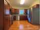 Cherry wood kitchen with stainless appliances, gray backsplash, and hardwoods at 228 31St Avenue Ne Ct, Hickory, NC 28601