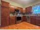 Cherry wood kitchen with stainless appliances and gray backsplash tile at 228 31St Avenue Ne Ct, Hickory, NC 28601