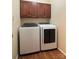 Laundry room with front load washer and dryer and wood cabinets at 228 31St Avenue Ne Ct, Hickory, NC 28601