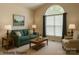 Cozy living room features neutral carpet, matching sofas and a bright window at 228 31St Avenue Ne Ct, Hickory, NC 28601