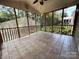 Relaxing screened porch featuring neutral tile flooring and a ceiling fan for comfortable outdoor living at 228 31St Avenue Ne Ct, Hickory, NC 28601