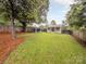 Large grassy backyard showcasing fenced-in yard with extra building at 2421 Morton St, Charlotte, NC 28208