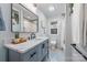 Bathroom featuring patterned tile, a modern vanity with countertop accessories, and a glass-enclosed shower at 2421 Morton St, Charlotte, NC 28208