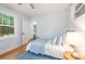 Bright bedroom features hardwood floors, a cozy rug, and a view to the rest of the home at 2421 Morton St, Charlotte, NC 28208
