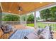 Spacious covered patio with wood ceiling, ceiling fan, comfortable seating, and a view of the backyard at 2421 Morton St, Charlotte, NC 28208