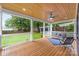 Wide view of covered wooden patio with comfortable seating and a ceiling fan overlooking a grass backyard at 2421 Morton St, Charlotte, NC 28208