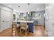 Bright kitchen features a blue island with seating, stainless steel appliances, and hardwood floors at 2421 Morton St, Charlotte, NC 28208